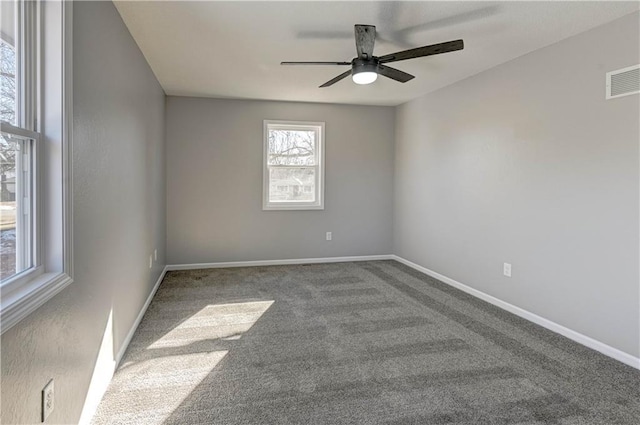 spare room with ceiling fan and carpet