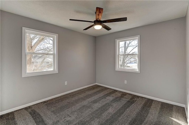 carpeted spare room featuring ceiling fan