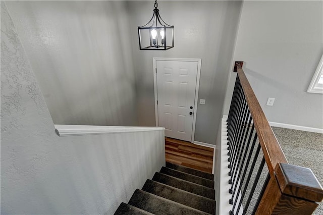 stairway with an inviting chandelier