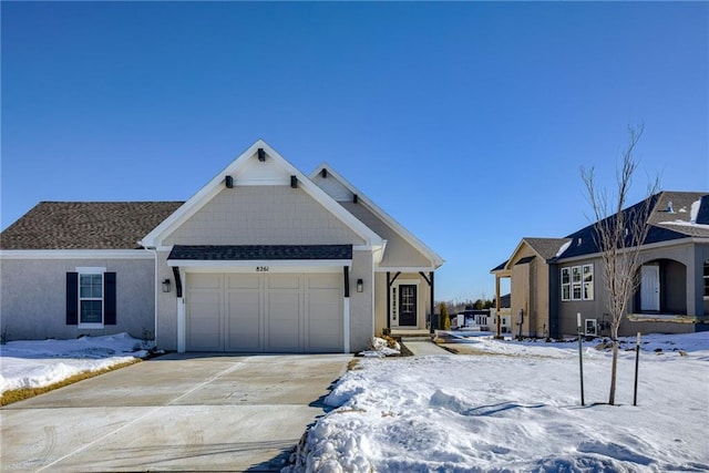 view of front facade with a garage, roof with shingles, driveway, and stucco siding