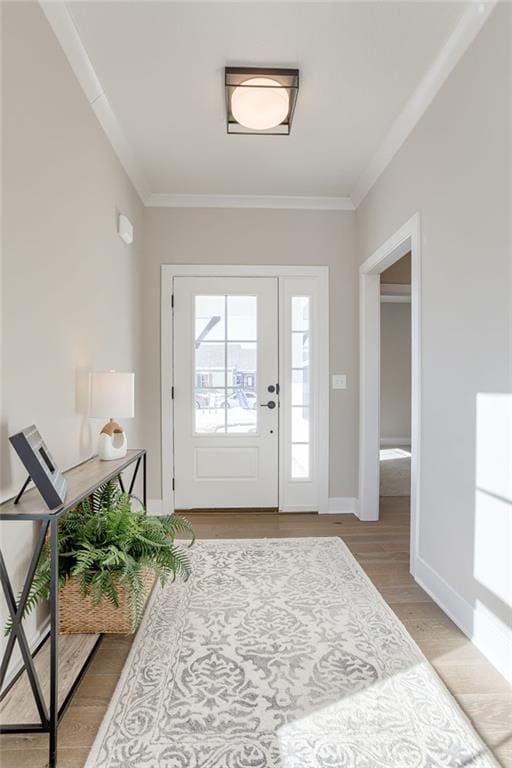 doorway featuring hardwood / wood-style flooring and ornamental molding