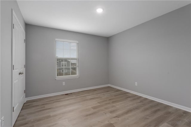 unfurnished room with light hardwood / wood-style floors