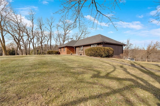 view of side of property with a lawn