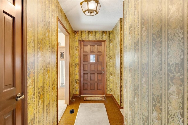 entryway featuring a textured ceiling