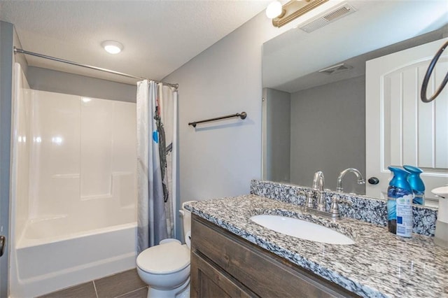 full bathroom featuring vanity, toilet, shower / bath combo, tile patterned floors, and a textured ceiling