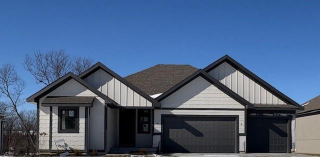 modern inspired farmhouse with a garage