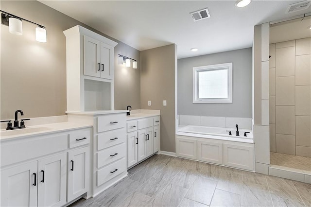 bathroom with a washtub and vanity