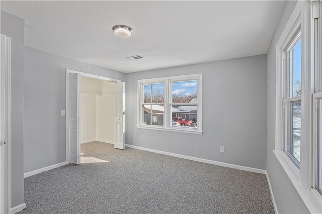 unfurnished bedroom featuring a closet and carpet flooring