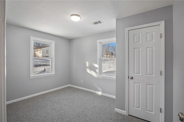 spare room with a healthy amount of sunlight and carpet flooring