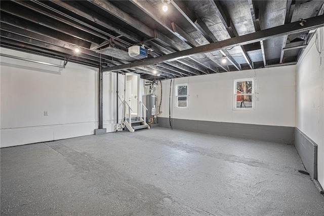 garage with a garage door opener and gas water heater