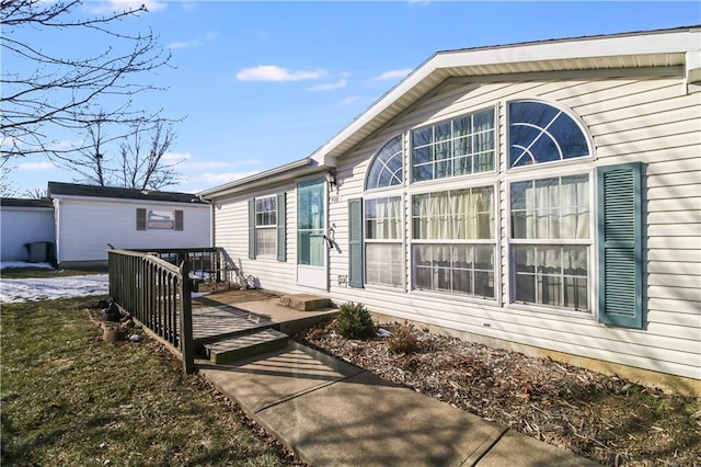 back of property with a wooden deck