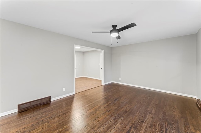 unfurnished room with dark hardwood / wood-style floors and ceiling fan