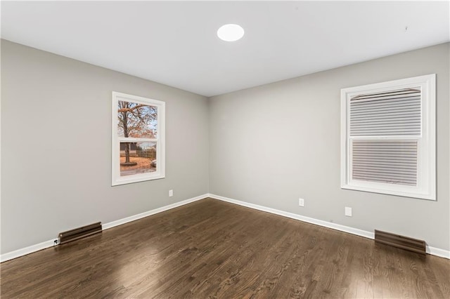 spare room featuring dark hardwood / wood-style flooring