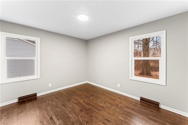 spare room featuring dark hardwood / wood-style floors