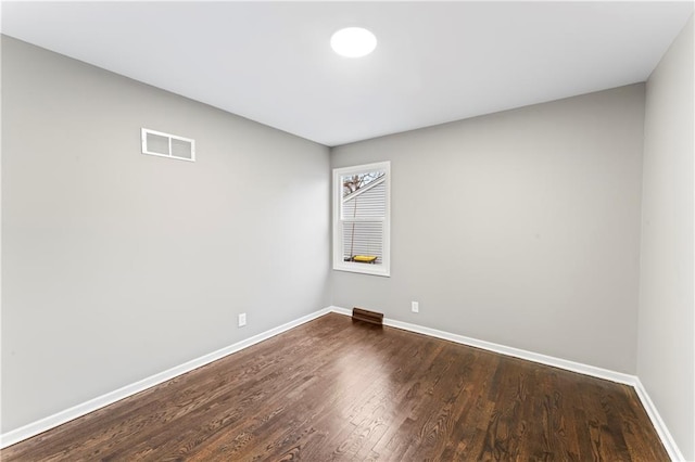 spare room with hardwood / wood-style flooring