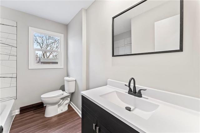 full bathroom with hardwood / wood-style flooring, vanity, bathing tub / shower combination, and toilet