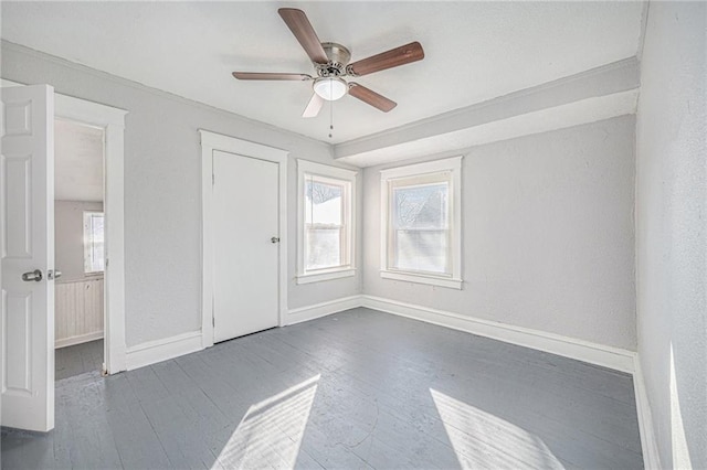 spare room featuring dark wood-type flooring and ceiling fan