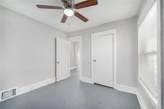 unfurnished bedroom with concrete flooring and ceiling fan