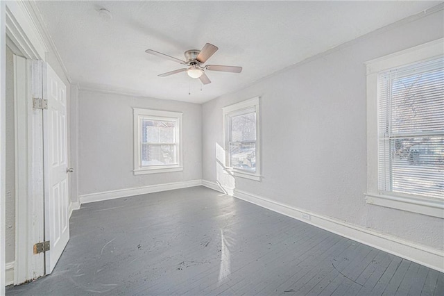 2463 Denver Ave, Kansas City, MO 64127 - empty room featuring a ceiling fan, dark wood-style floors, and crown molding