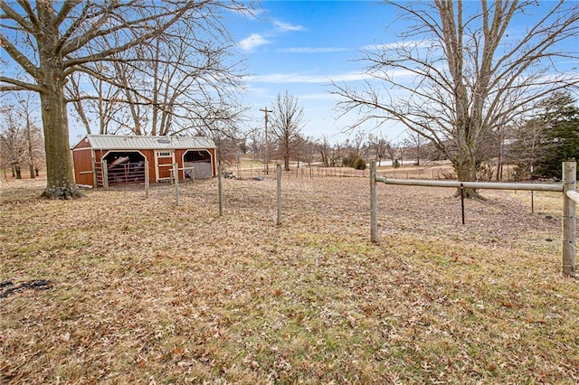 view of yard featuring an outdoor structure and a rural view