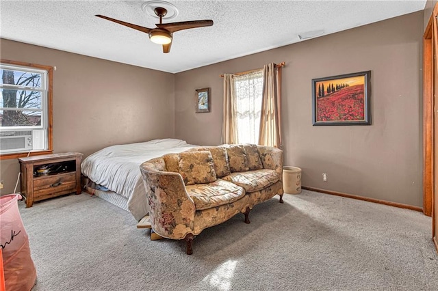 carpeted bedroom featuring ceiling fan and a textured ceiling