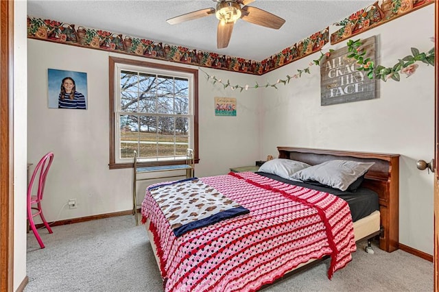 bedroom featuring ceiling fan, carpet flooring, and a textured ceiling