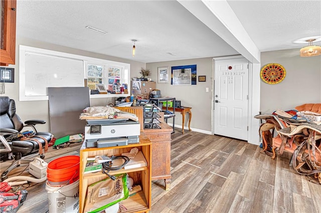 game room featuring hardwood / wood-style flooring and a textured ceiling