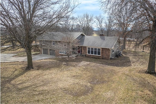 view of front of property with a garage and a front lawn