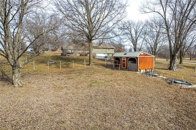 view of yard with a rural view and an outdoor structure