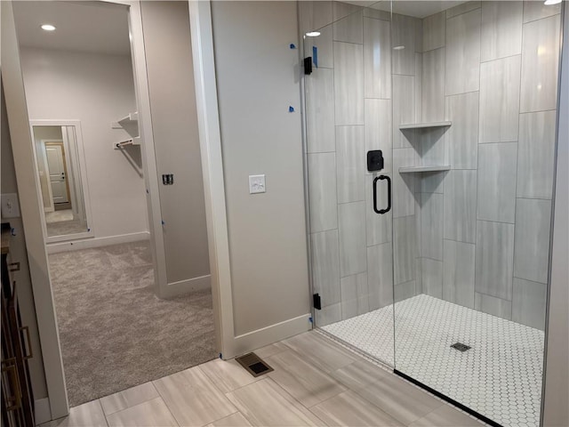 full bathroom featuring a stall shower, baseboards, and visible vents