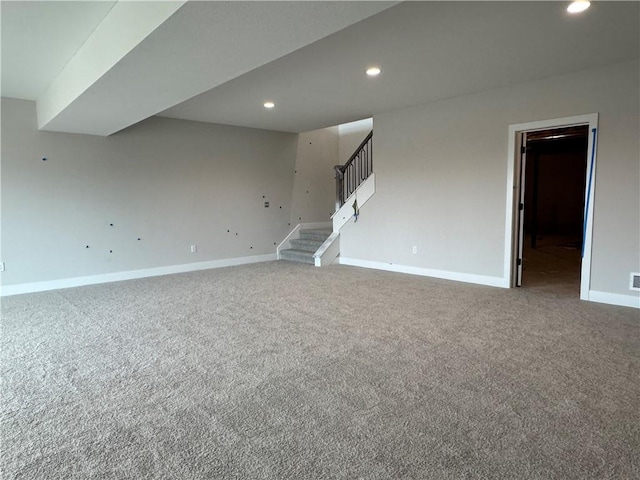 carpeted empty room with baseboards, stairway, and recessed lighting