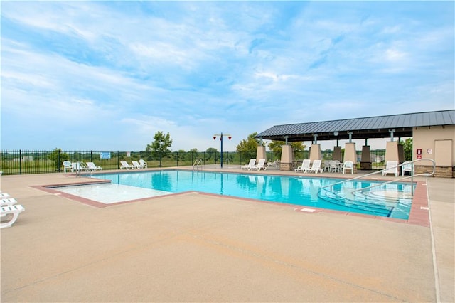 pool featuring a patio and fence