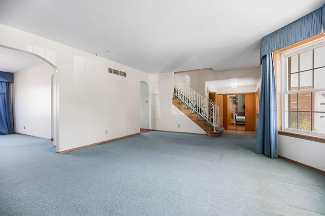 unfurnished living room featuring carpet floors