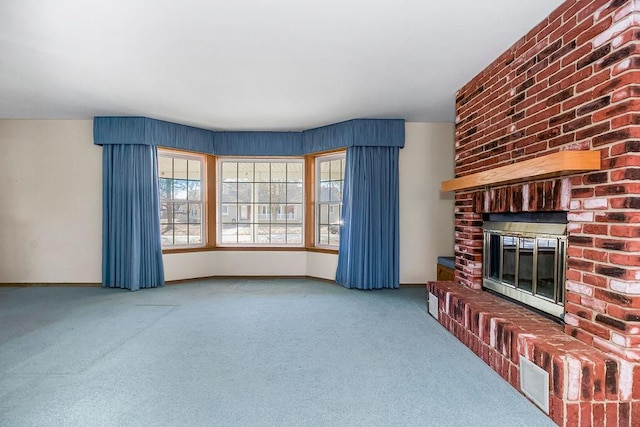 carpeted living room with a brick fireplace