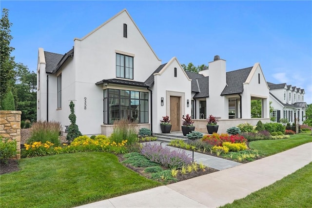 9358 Juniper Reserve Dr, Prairie Village, KS 66207 - view of front of property with stucco siding, a front yard, and a chimney