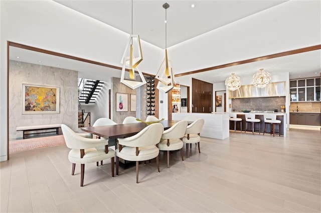 9358 Juniper Reserve Dr, Prairie Village, KS 66207 - dining room featuring a chandelier and light wood-style floors