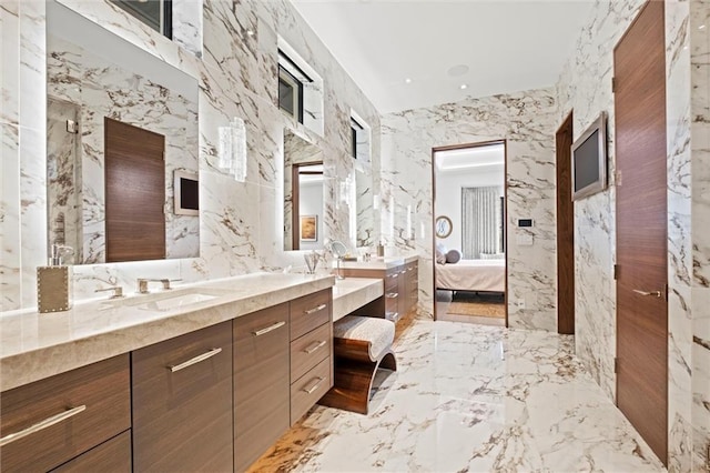 9358 Juniper Reserve Dr, Prairie Village, KS 66207 - bathroom with double vanity, marble tiled floors, connected bathroom, and stone wall