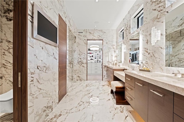 9358 Juniper Reserve Dr, Prairie Village, KS 66207 - full bathroom featuring two vanities, marble tiled flooring, stone wall, and tile walls