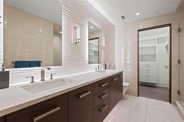 9358 Juniper Reserve Dr, Prairie Village, KS 66207 - full bathroom featuring double vanity, a shower stall, and a spacious closet