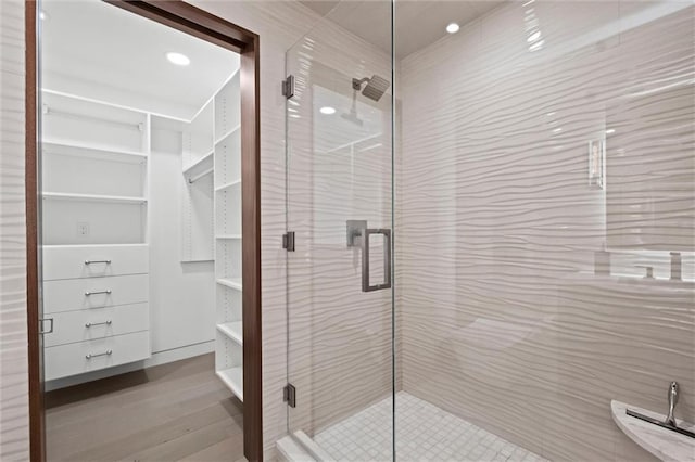9358 Juniper Reserve Dr, Prairie Village, KS 66207 - bathroom with a stall shower, wood finished floors, and a walk in closet