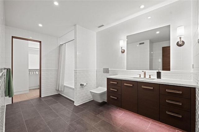 9358 Juniper Reserve Dr, Prairie Village, KS 66207 - bathroom featuring tile walls, vanity, shower / tub combo with curtain, recessed lighting, and tile patterned flooring