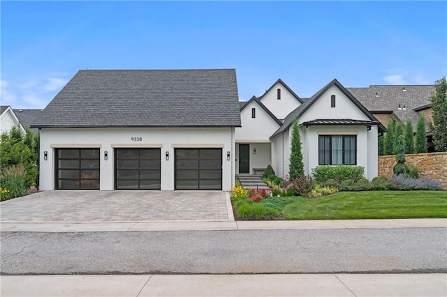 9358 Juniper Reserve Dr, Prairie Village, KS 66207 - modern inspired farmhouse with stucco siding, a front yard, an attached garage, decorative driveway, and a standing seam roof