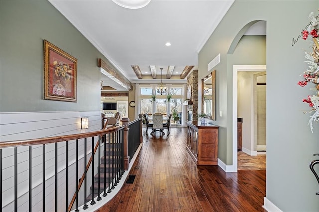 corridor with ornamental molding and dark hardwood / wood-style floors