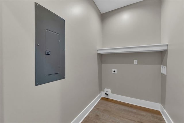 laundry room with electric panel, light wood-type flooring, and electric dryer hookup