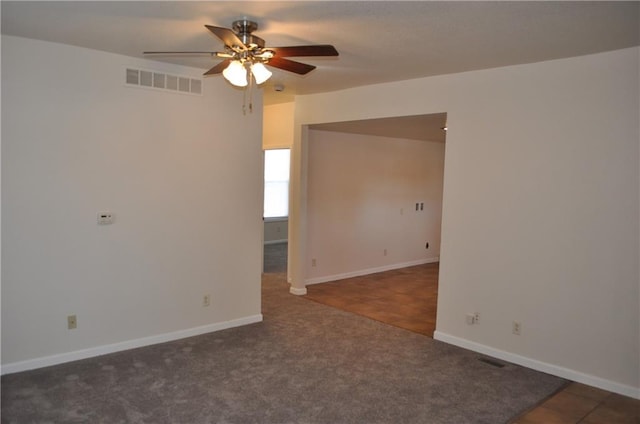 carpeted spare room with ceiling fan