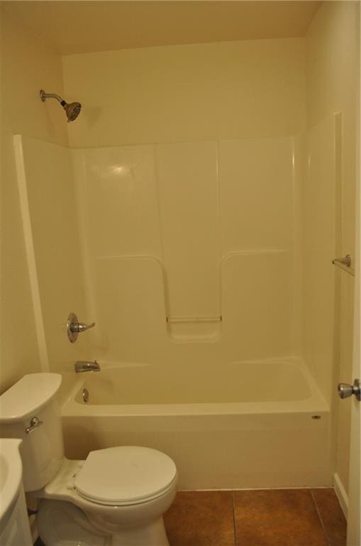 bathroom with toilet, tub / shower combination, and tile patterned flooring