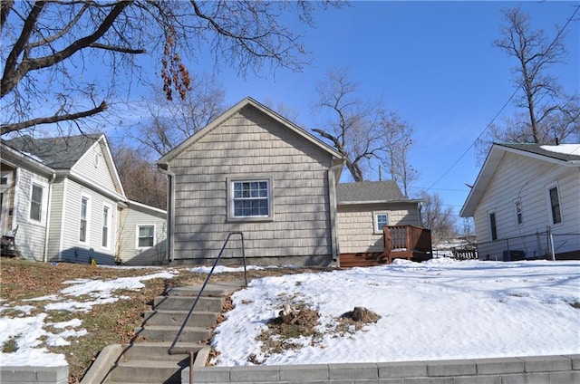 snow covered property featuring a wooden deck