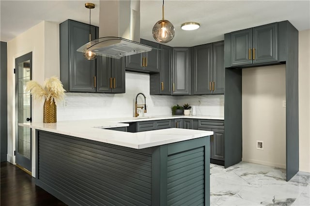 kitchen with island range hood, decorative light fixtures, sink, decorative backsplash, and kitchen peninsula