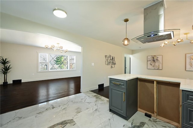 kitchen with pendant lighting, a notable chandelier, and island range hood