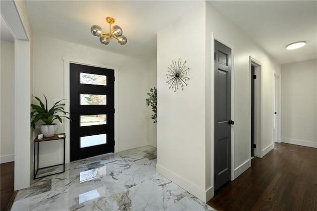 foyer entrance with a notable chandelier